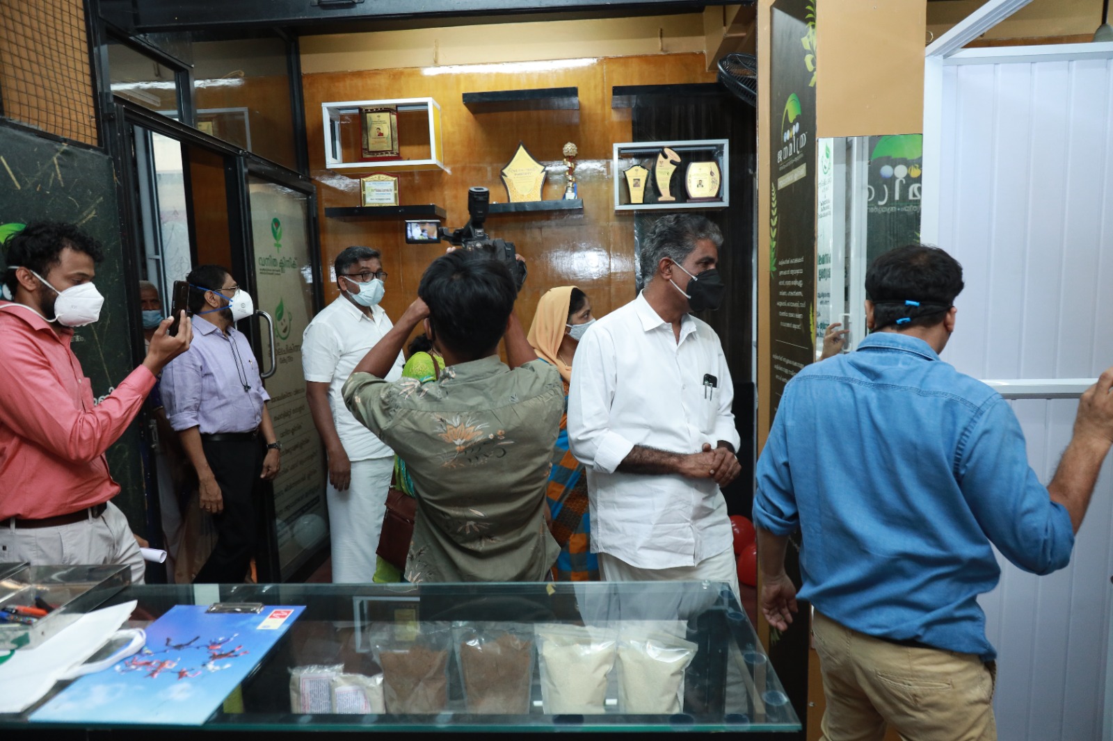 Guests being shown round the Janamitra Ayurveda Centre after the opening, awards on the shelf behind