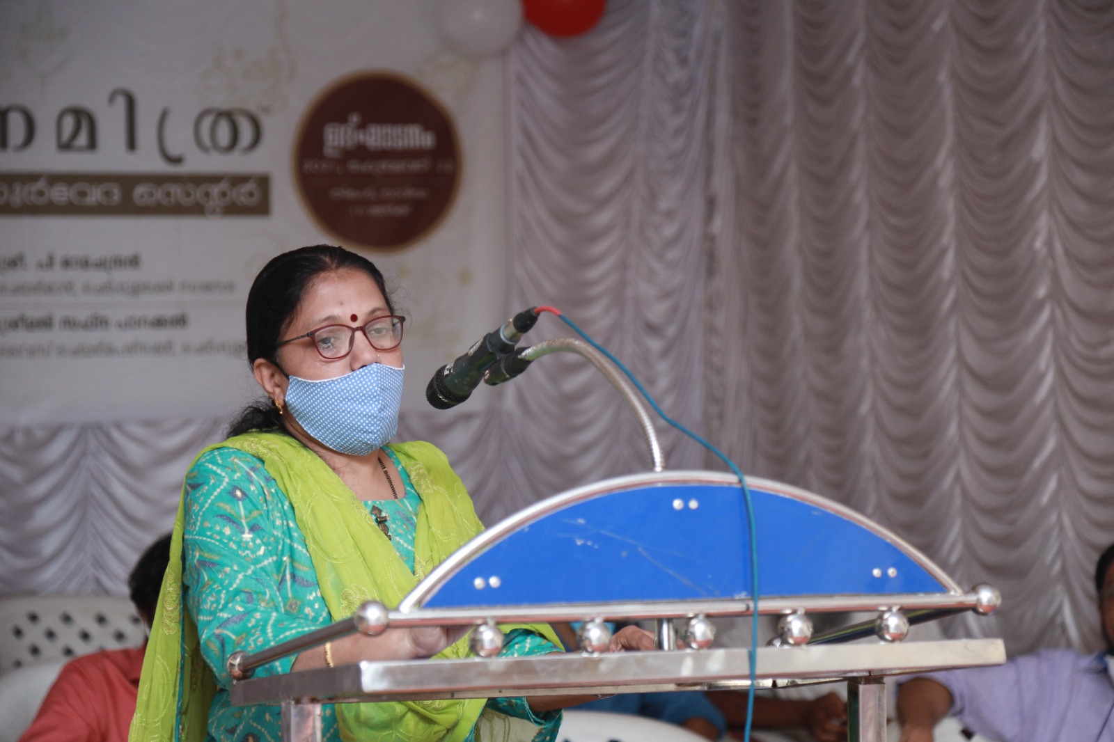 An address from the podium at the Janamitra Ayurveda Centre opening