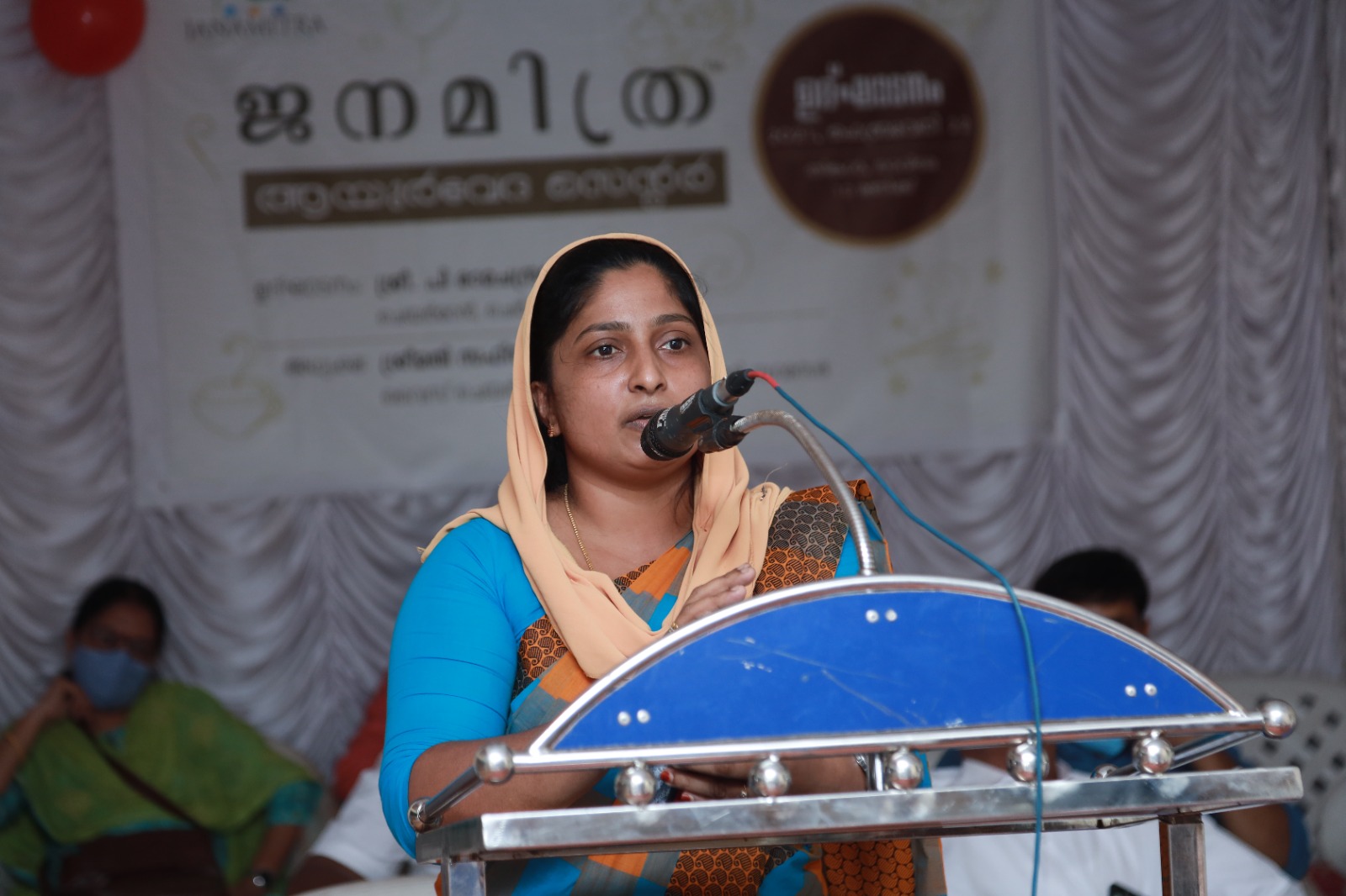 A speaker at the podium during the Janamitra Ayurveda Centre opening