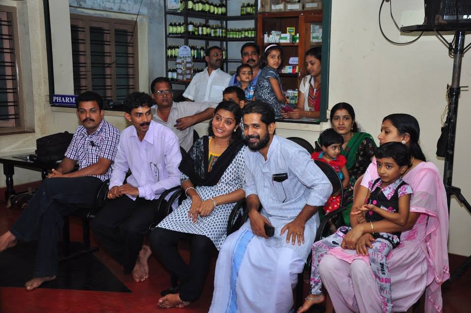 The audience at a Janamitra community programme, families seated together