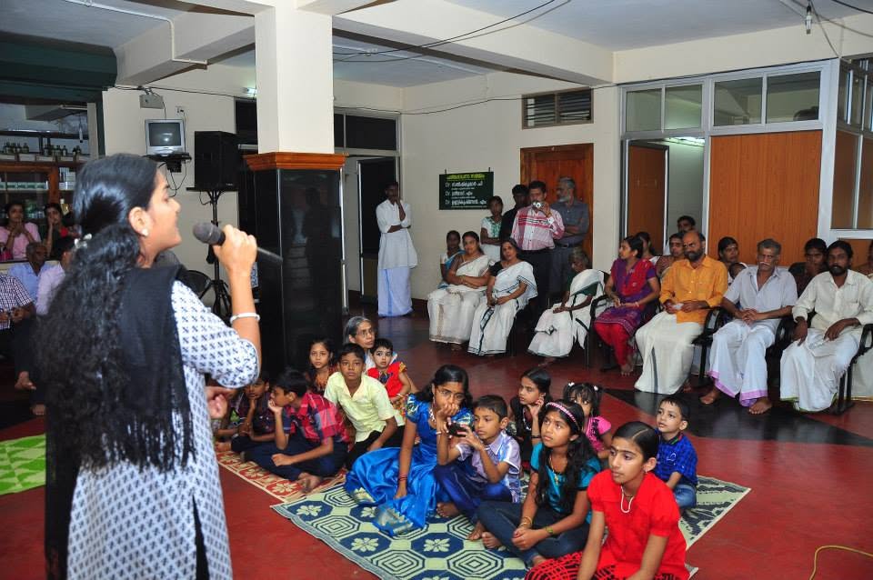 A session for children, who are seated on mats in front of the speaker
