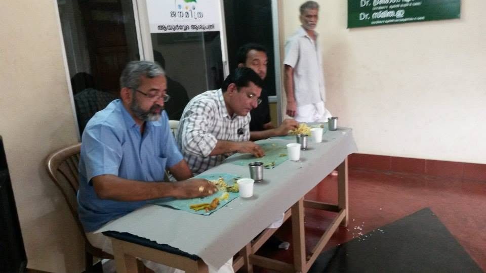 A consultation desk at a Janamitra camp, the doctors' board on the wall behind